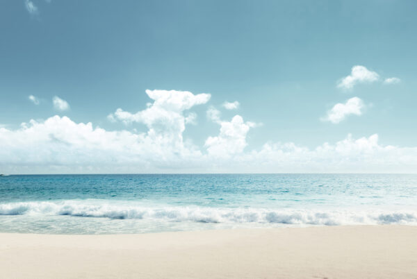 A beach with waves crashing on the sand A beach with waves crashing on the sand