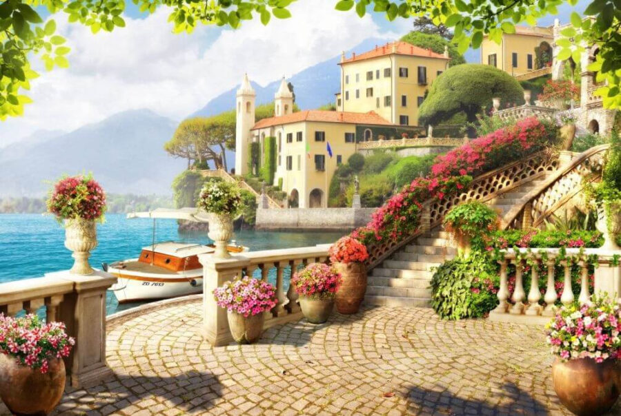 Stone walkway with stairs and flowers on the side of the water