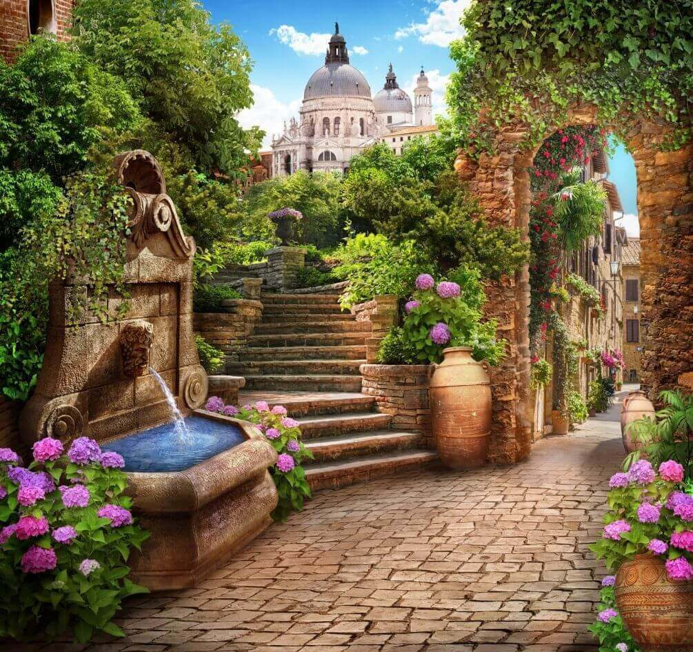 Stone path with a fountain and stairs and flowers Stone path with a fountain and stairs and flowers