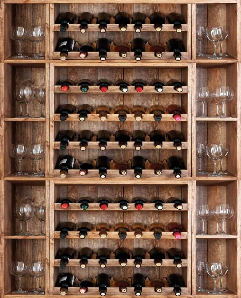 Wine bottles and glasses on a shelf