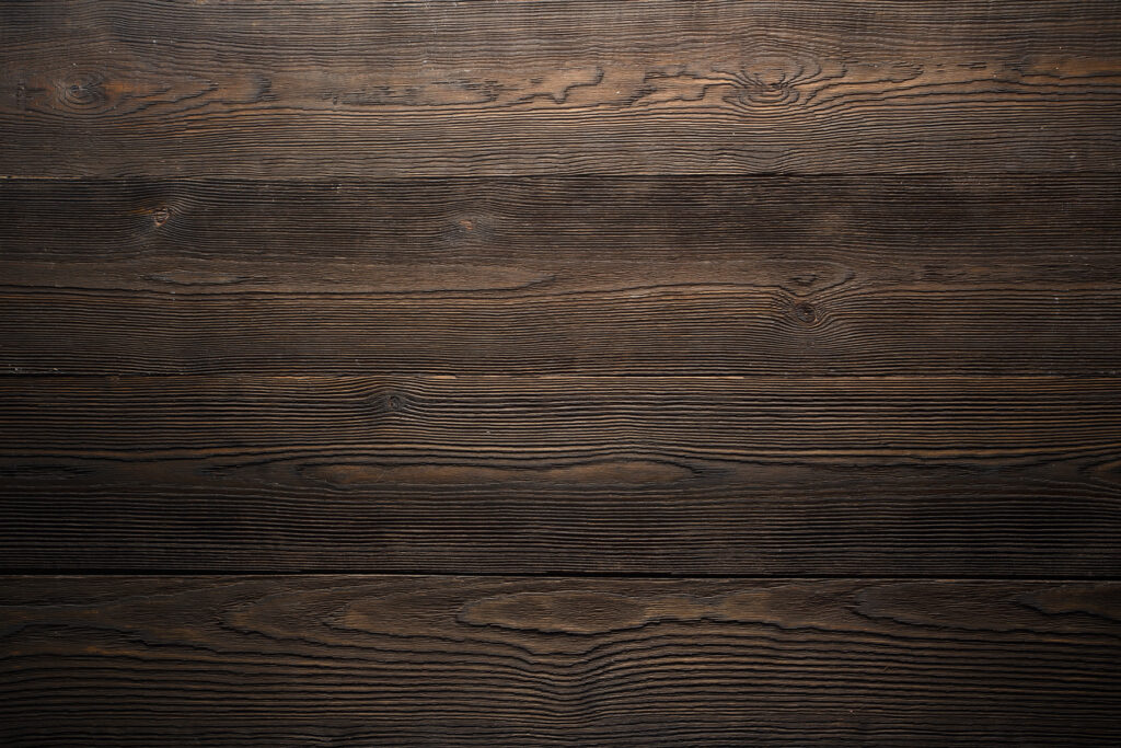 Dark wood surface with a few cracks Dark wood surface with a few cracks