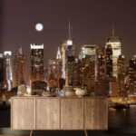 Wall murals City skyline at night with the moon in the sky