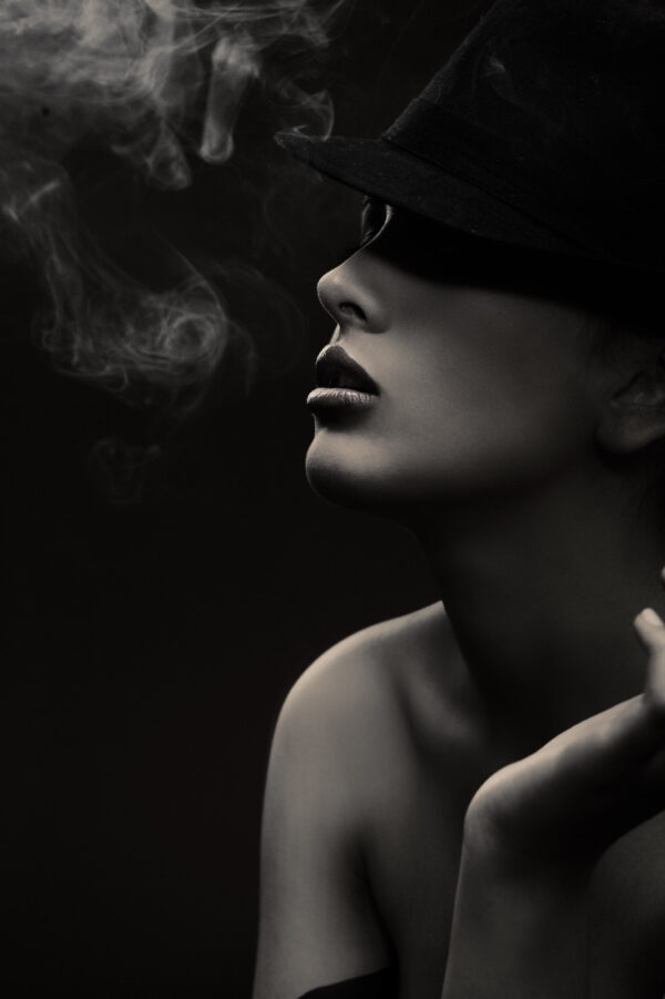 Woman wearing a hat and smoking Woman wearing a hat and smoking