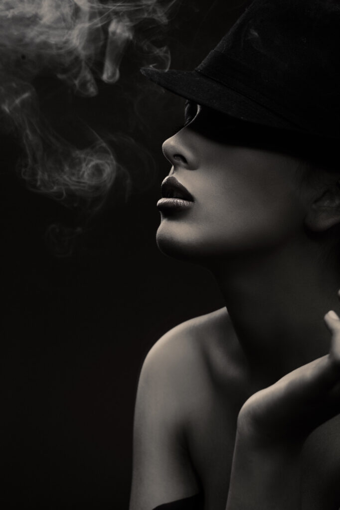 Woman wearing a hat and smoking Woman wearing a hat and smoking