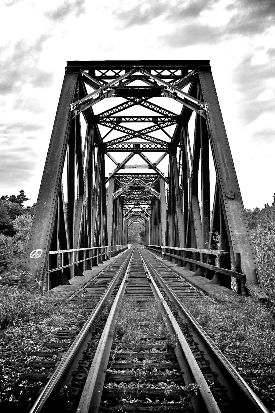 Train tracks going through a bridge