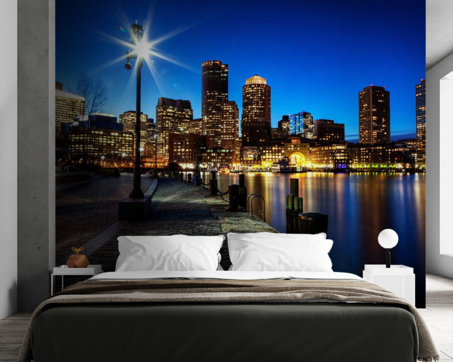 City skyline at night with a body of water