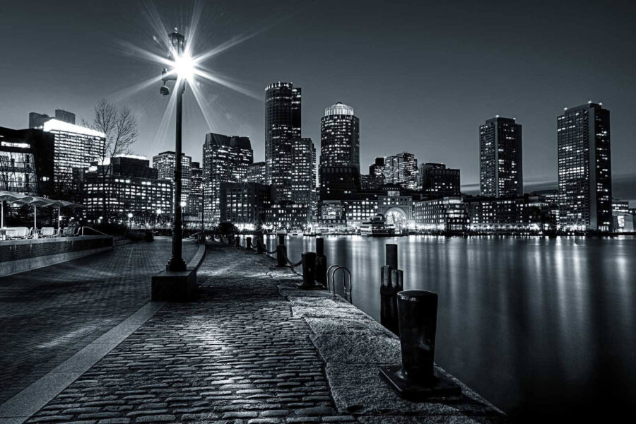 A city skyline with lights on the water