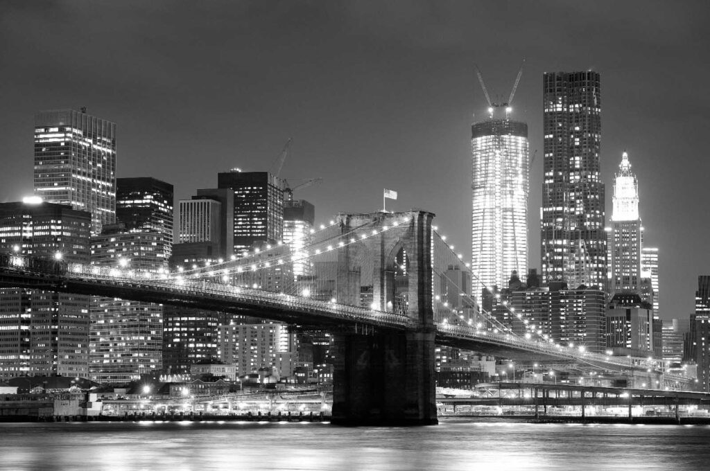 Bridge over water with city skyline in the background Bridge over water with city skyline in the background