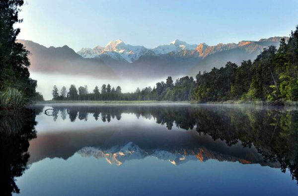Lake with trees and mountains in the background Lake with trees and mountains in the background
