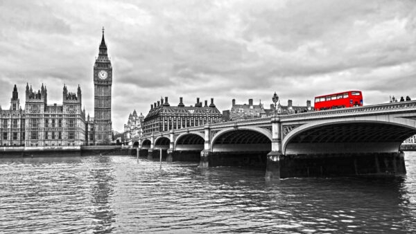 Bridge over water with a clock tower and a red bus Bridge over water with a clock tower and a red bus