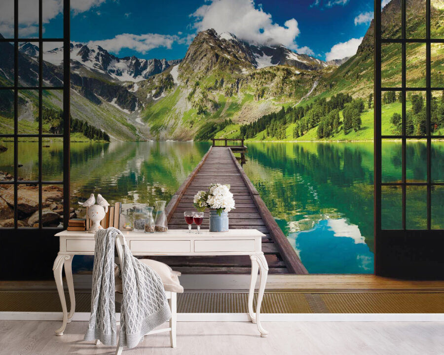 View of a lake from a room with a wooden dock and mountains