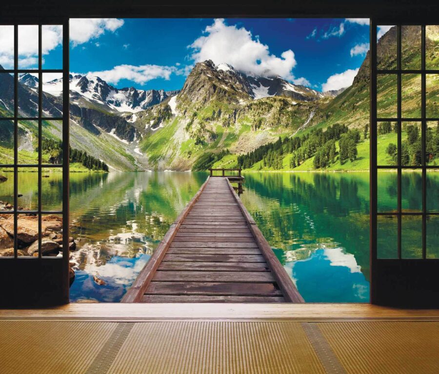 View of a lake from a room with a wooden dock and mountains