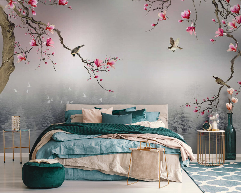 Tree branches with pink flowers and birds flying over water