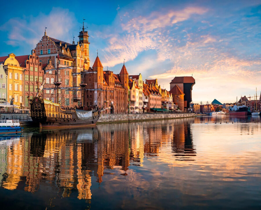 Body of water with buildings and boats in it Body of water with buildings and boats in it
