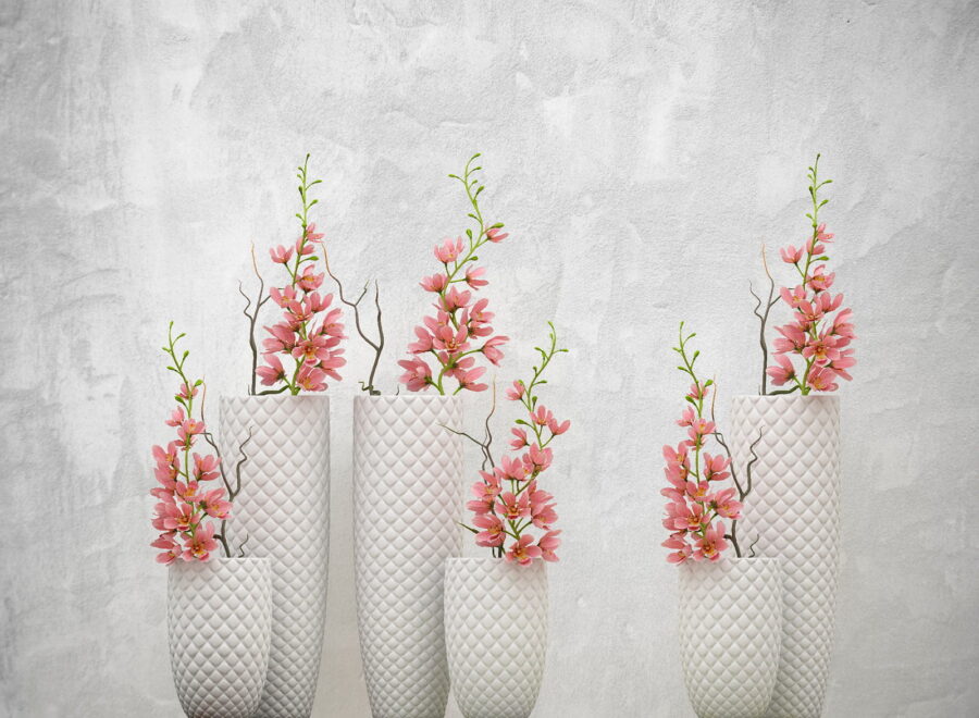 Group of white vases with pink flowers