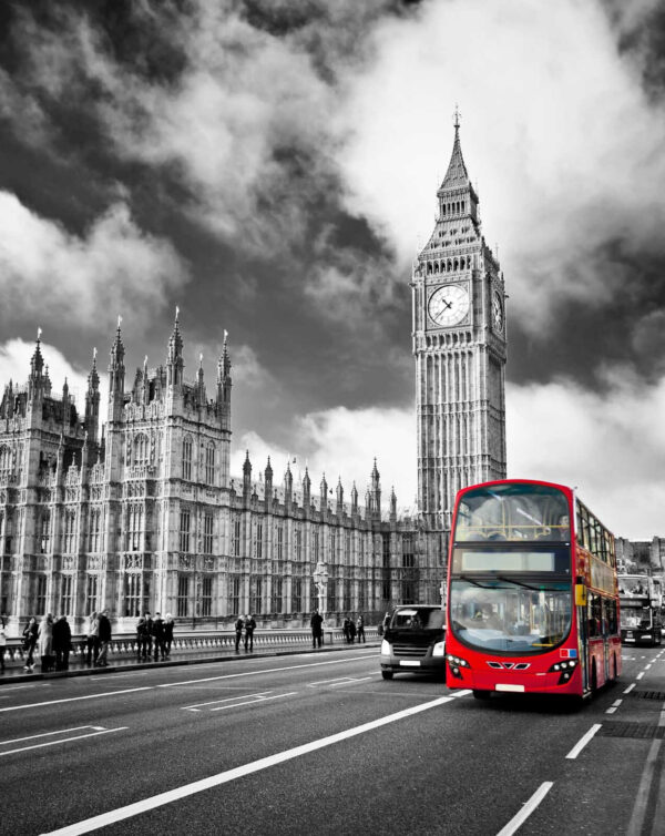 Red double decker bus on a street with a clock tower in the background Red double decker bus on a street with a clock tower in the background
