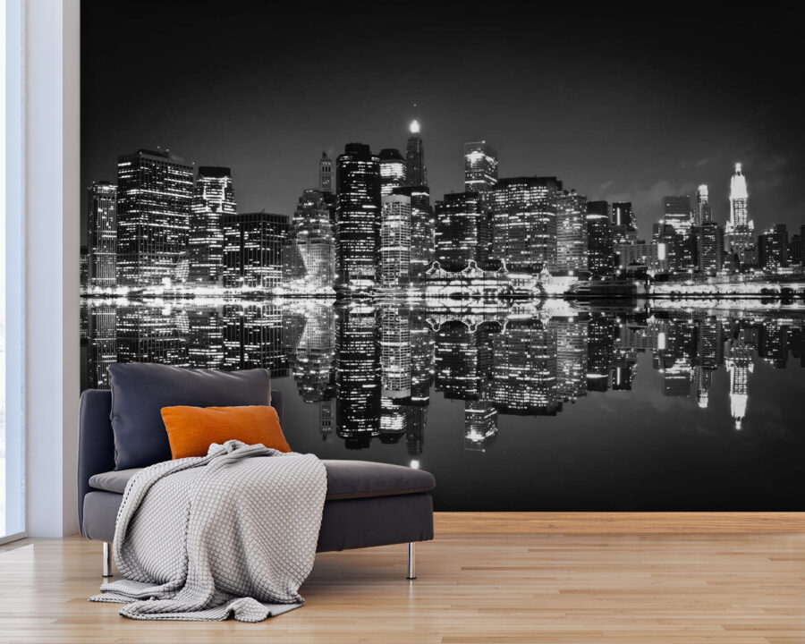 City skyline at night with lights reflecting on water