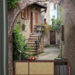 Wall mural Stone archway with plants and stairs