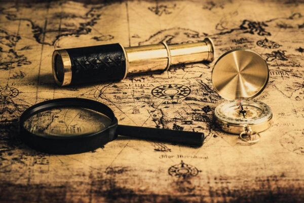 Magnifying glass and a telescope on a map Magnifying glass and a telescope on a map