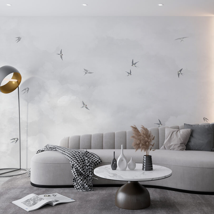 A group of birds flying in the sky