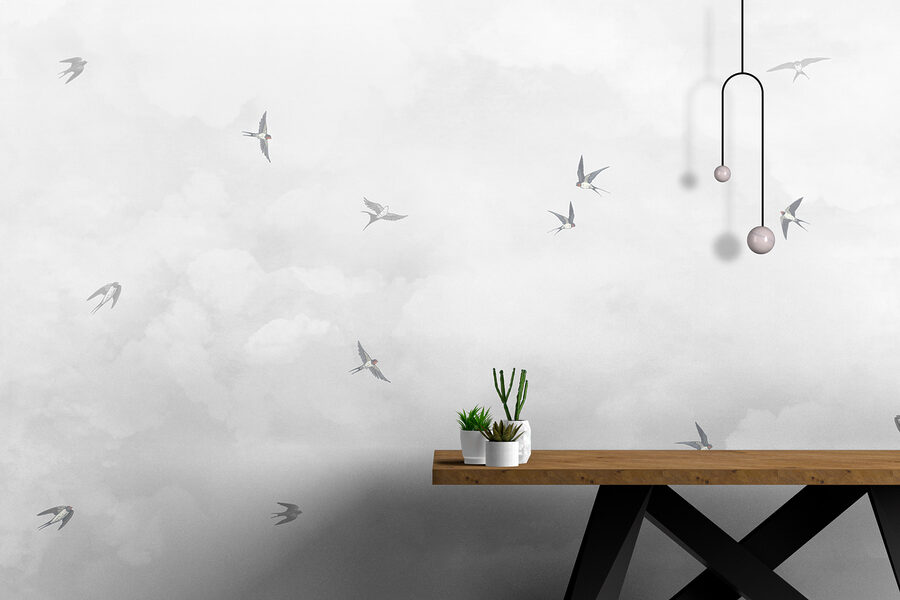 A group of birds flying in the sky