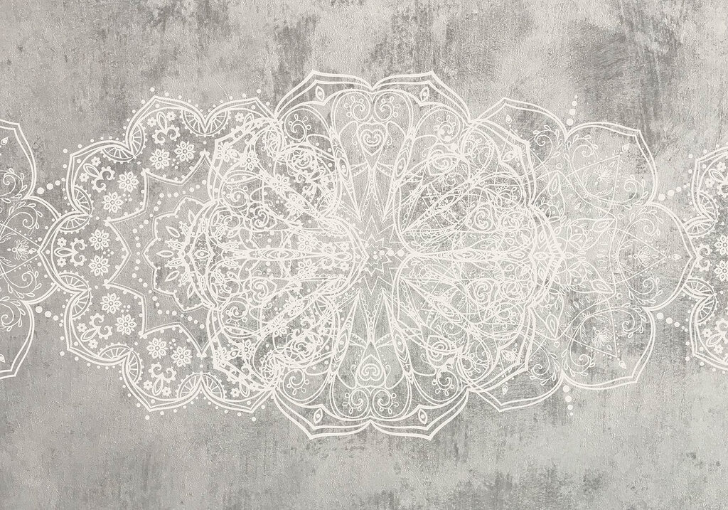 White ornate design on a grey surface White ornate design on a grey surface