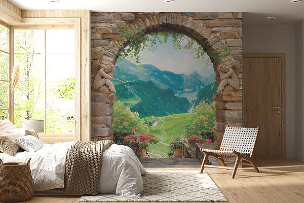 Stone archway with stone statues and a view of a valley and mountains Stone archway with stone statues and a view of a valley and mountains