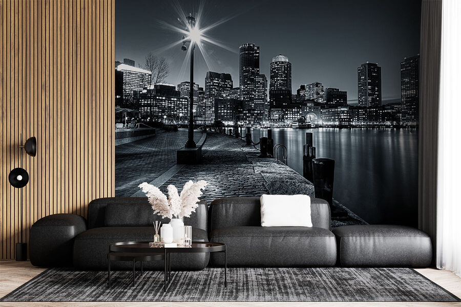 A city skyline with lights on the water