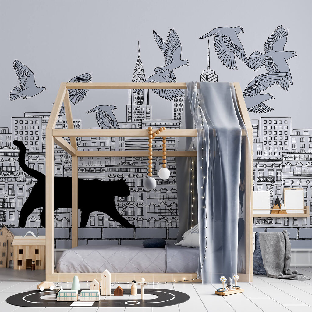 Cat walking on a wall with birds flying in the sky