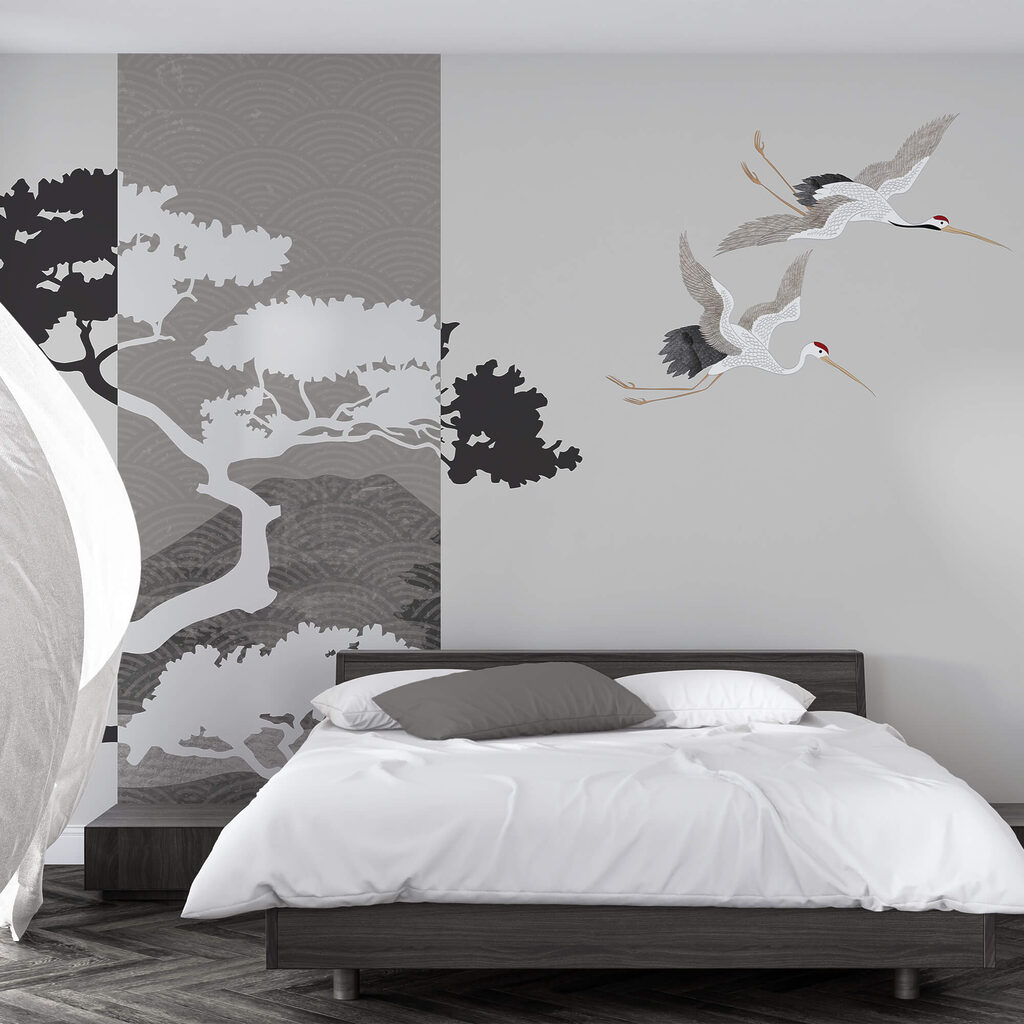 Couple of cranes flying next to a tree