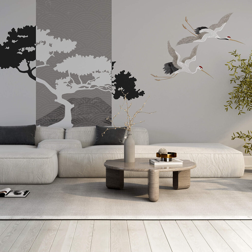 Couple of cranes flying next to a tree