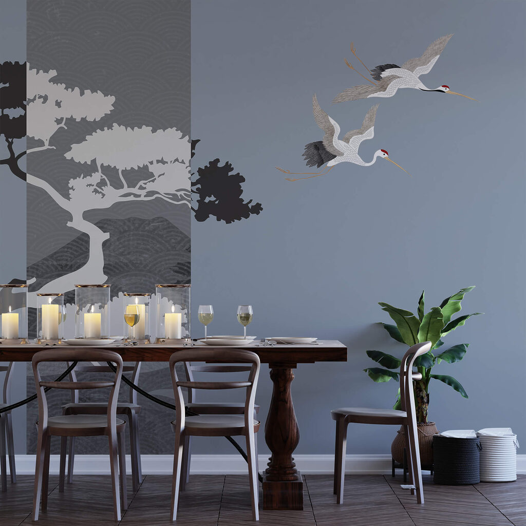 Couple of cranes flying next to a tree