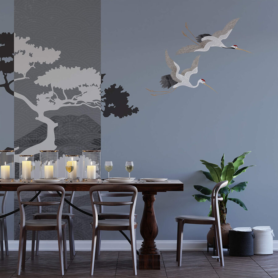Wall murals Couple of cranes flying next to a tree