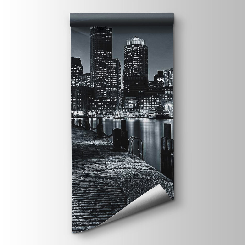 A city skyline with lights on the water