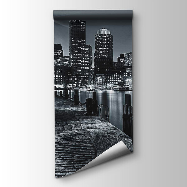 A city skyline with lights on the water